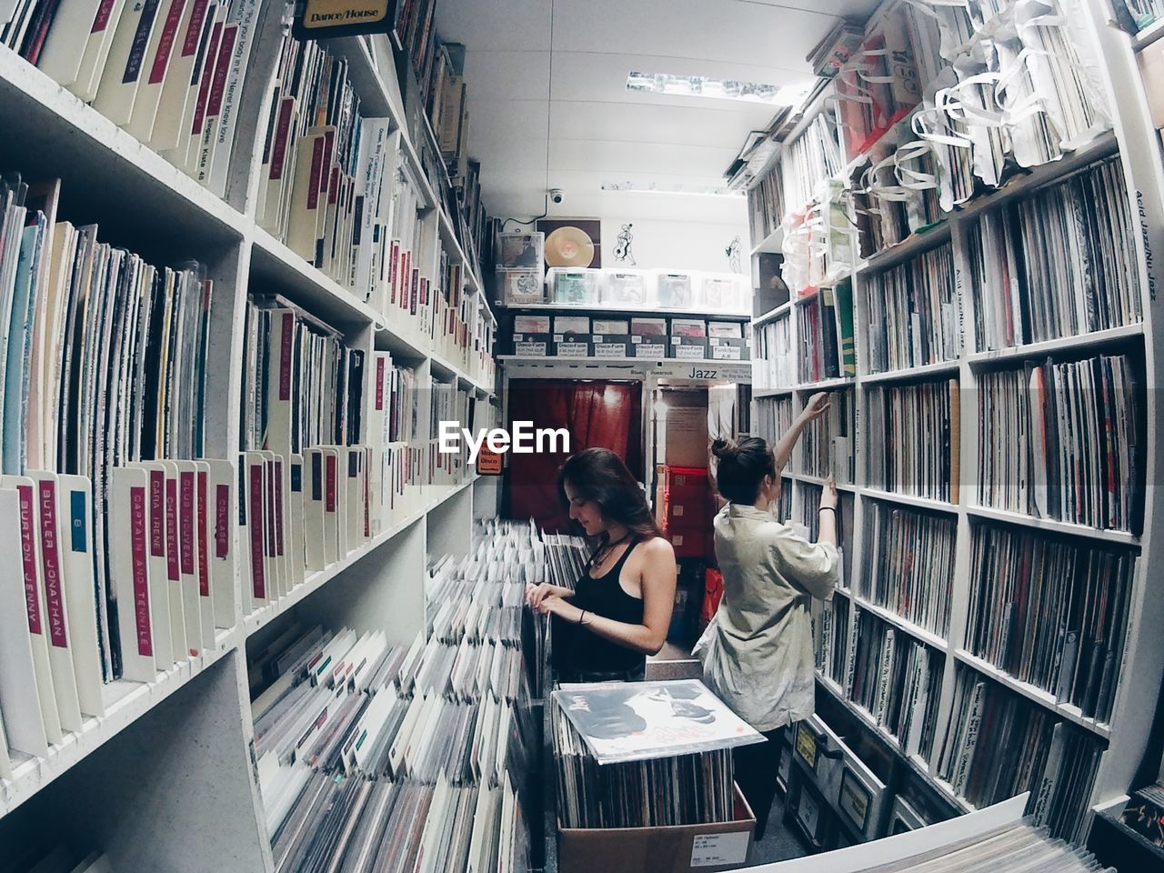 High angle view of women choosing music record at store