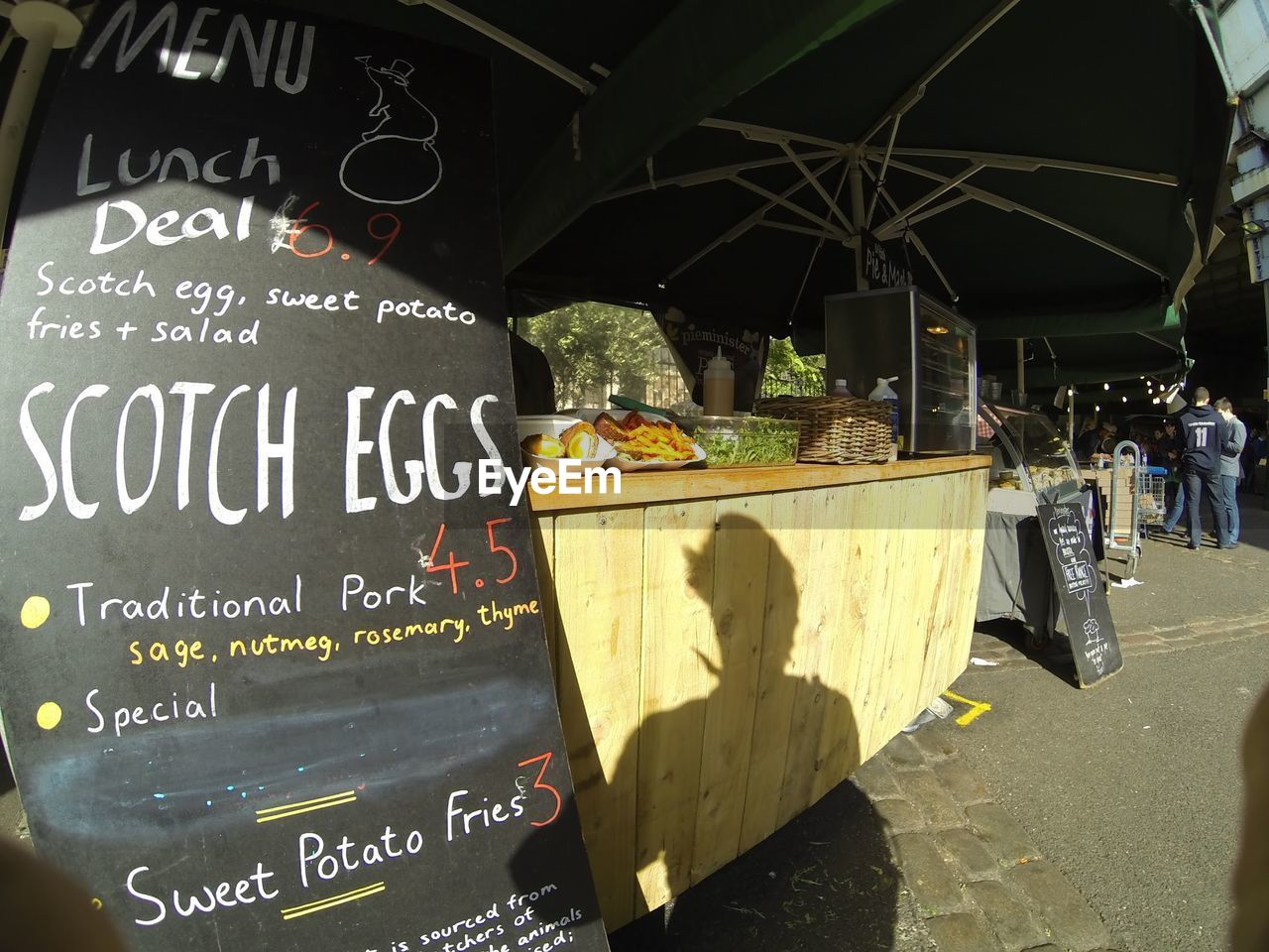 Shadow of person on market stall