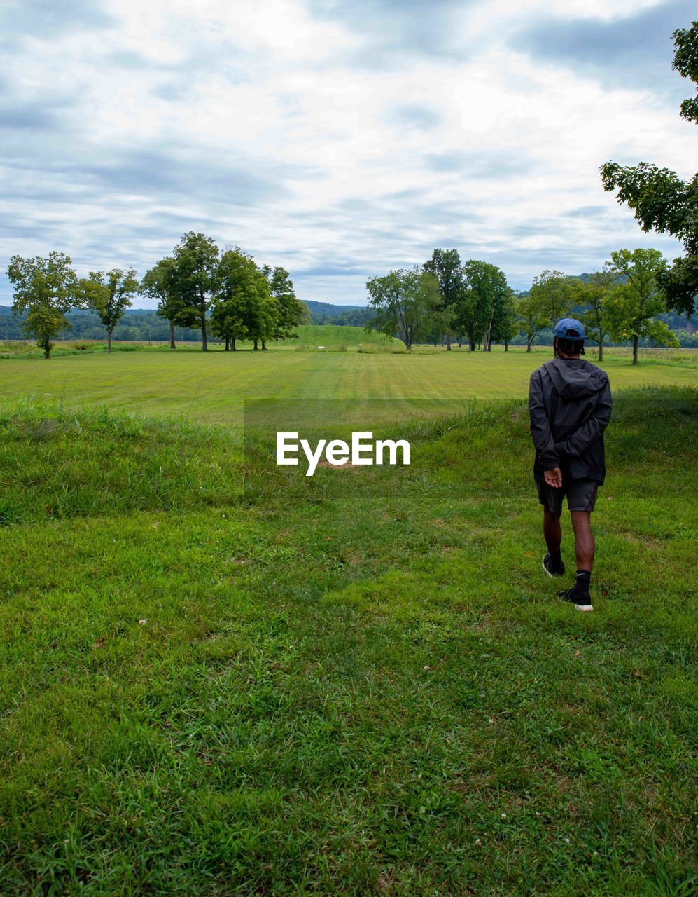 Young man at large native american burial mound at seip earthworks ohio