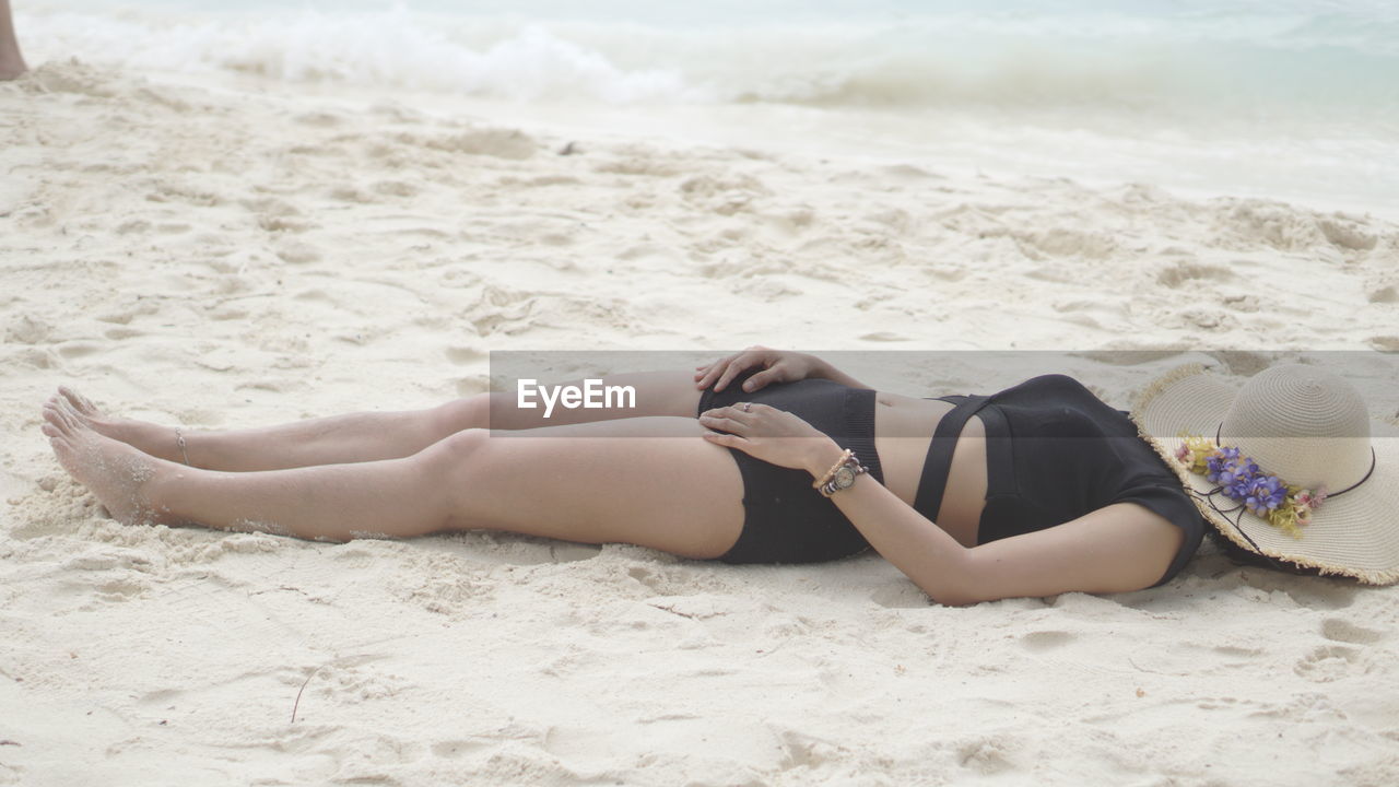 Woman lying down at beach
