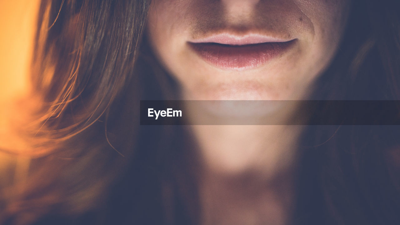 Close-up midsection of smiling young woman