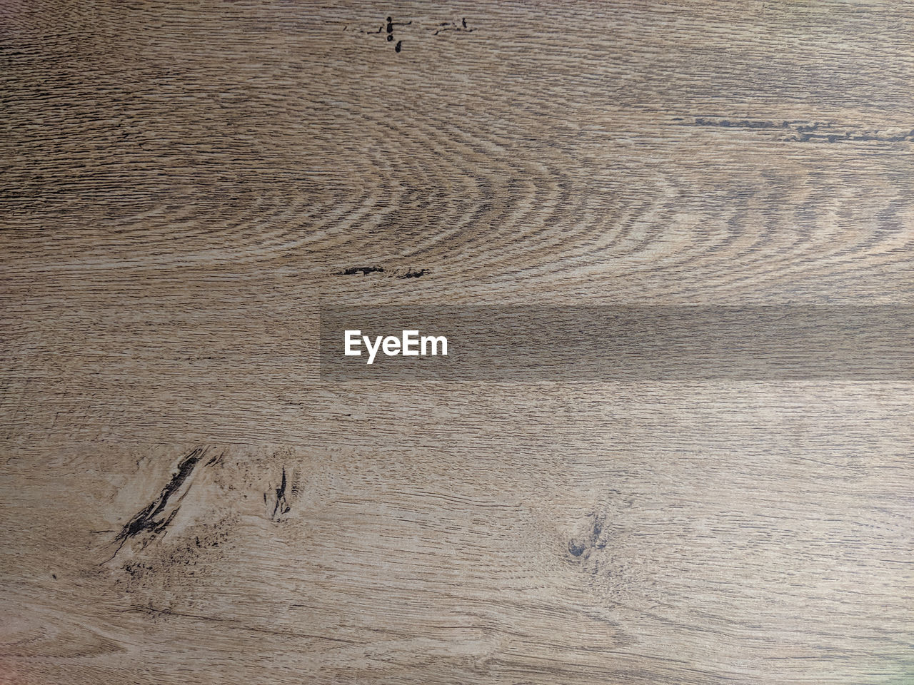 HIGH ANGLE VIEW OF WOOD ON SAND