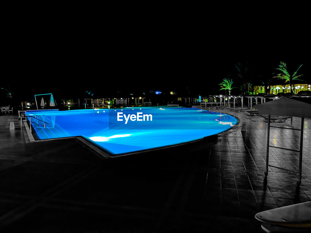 ILLUMINATED SWIMMING POOL AT NIGHT