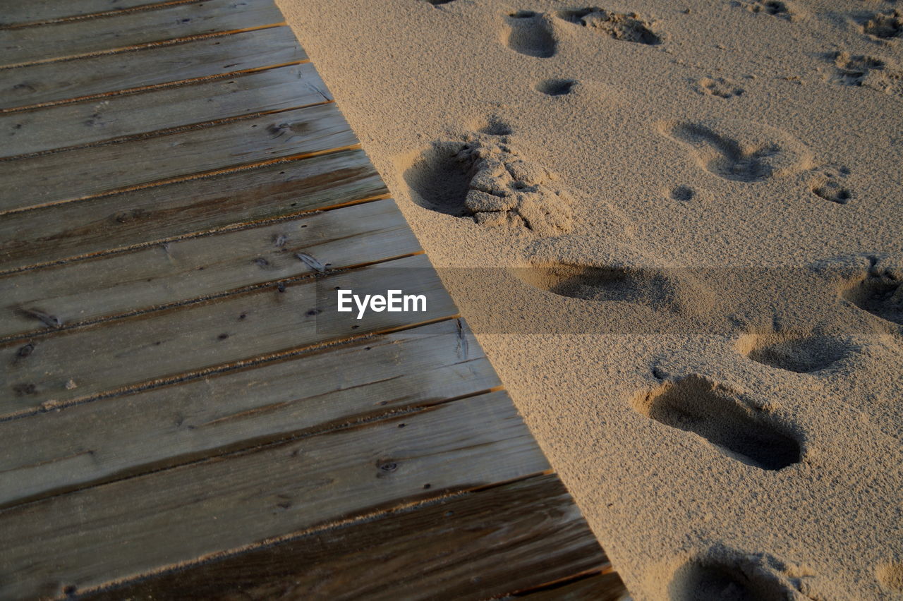 High angle view of footprints on sand