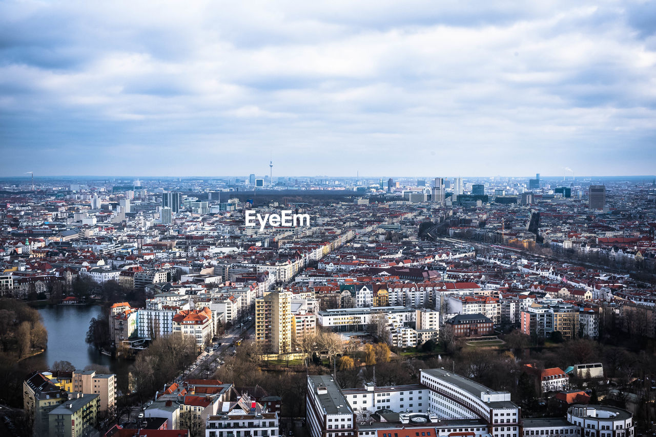 High angle view of cityscape against cloudy sky
