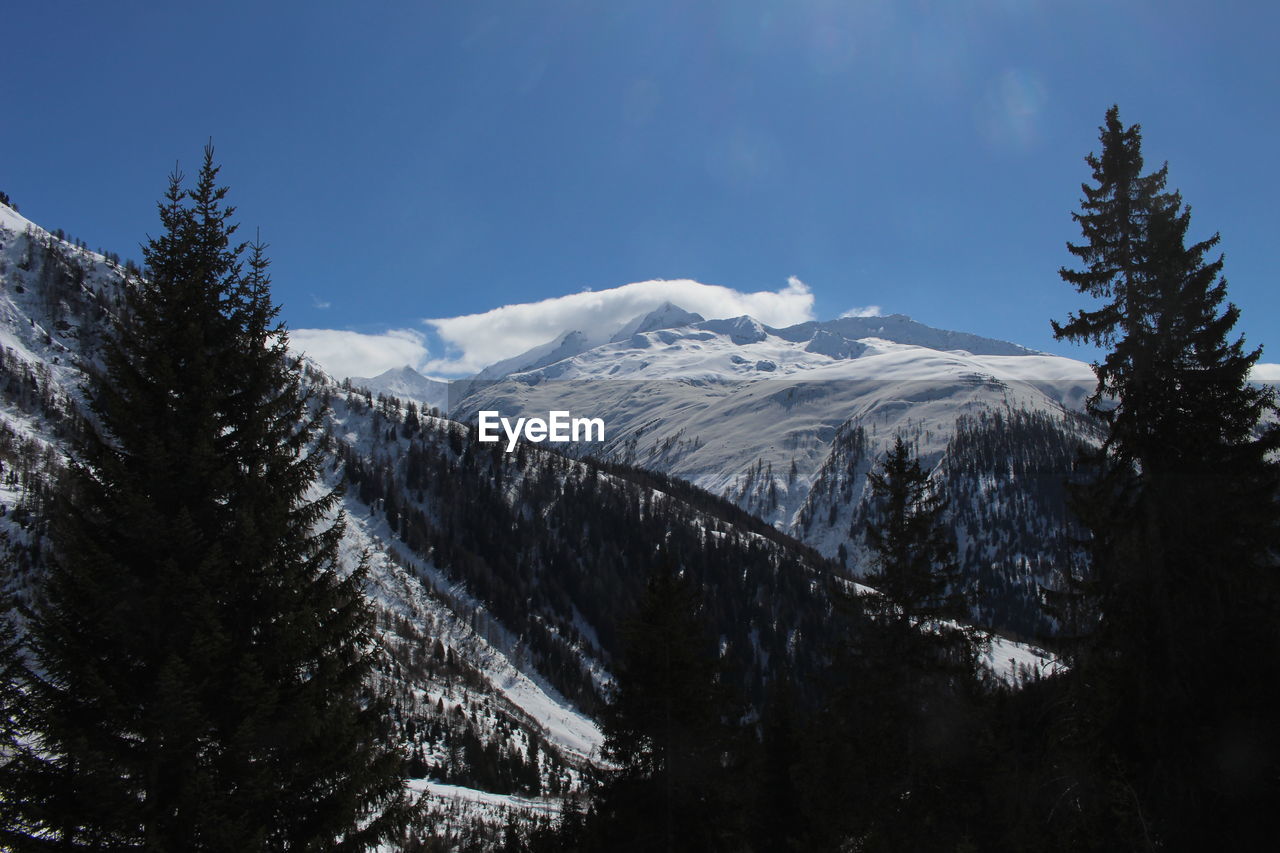 Scenic view of mountains against cloudy sky