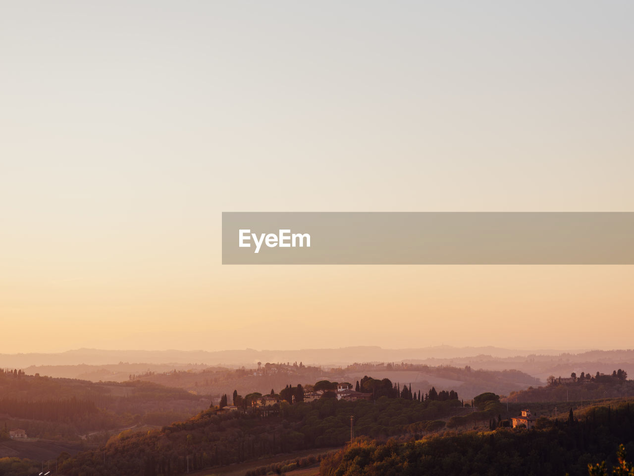 Scenic view of landscape against clear sky during sunset in toscan, italy