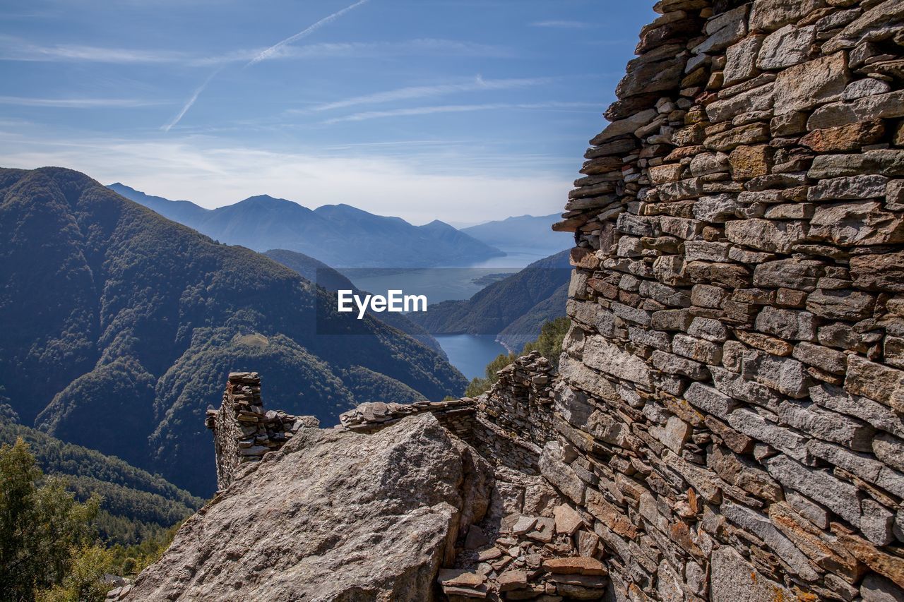 SCENIC VIEW OF MOUNTAINS AGAINST SKY DURING SUNNY DAY