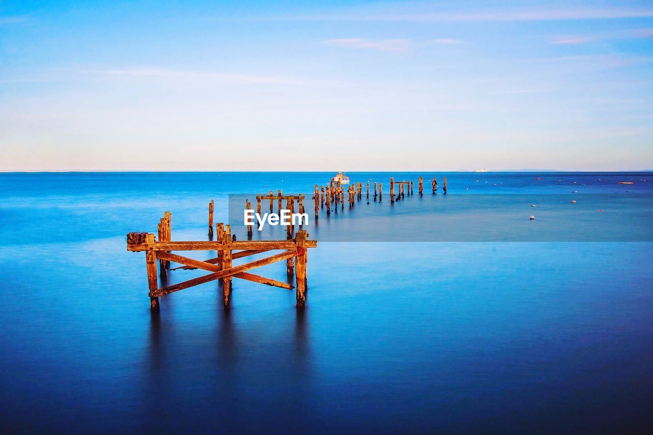 Wooden posts in sea