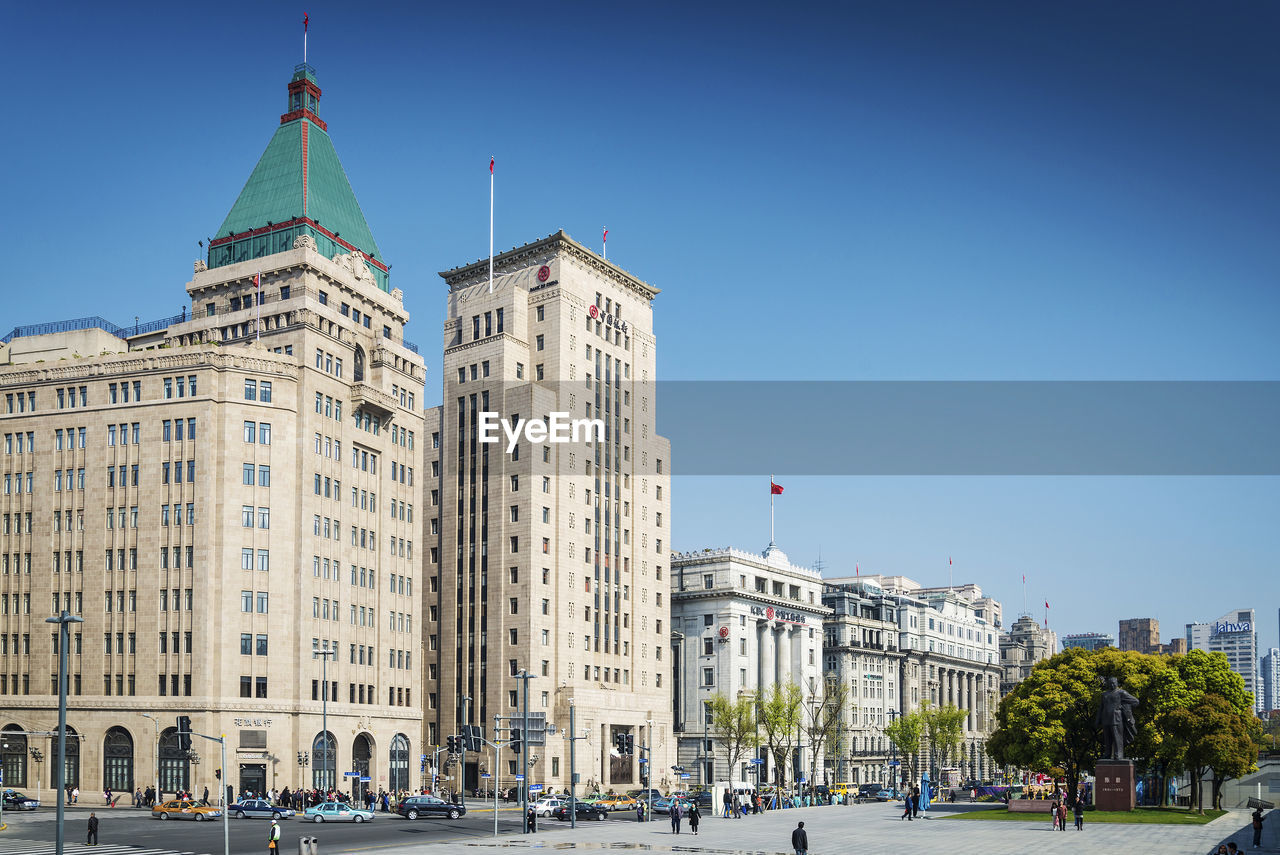 View of buildings against clear blue sky