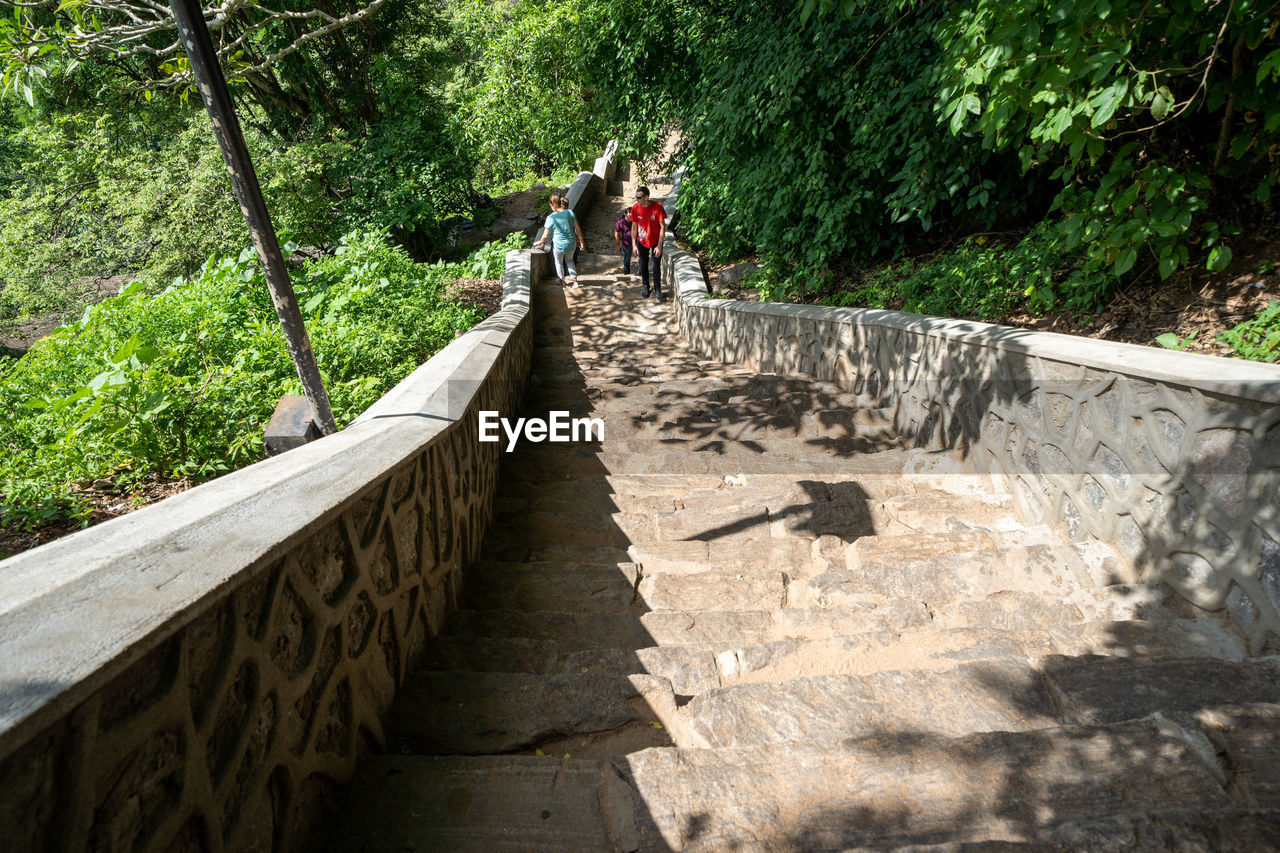 PEOPLE WALKING ON FOOTBRIDGE