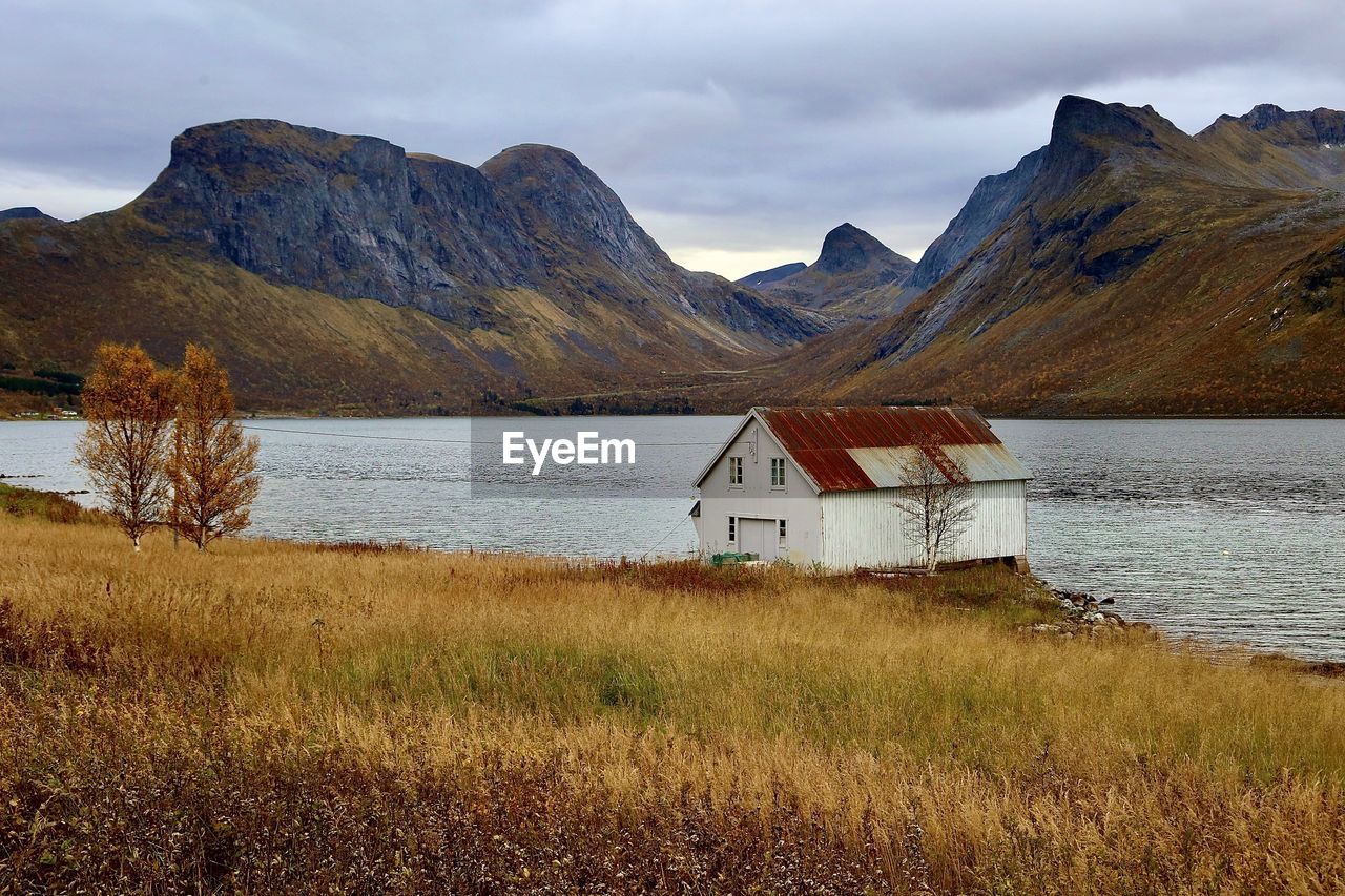 Scenic view of lake and mountains against sky, senja in norway