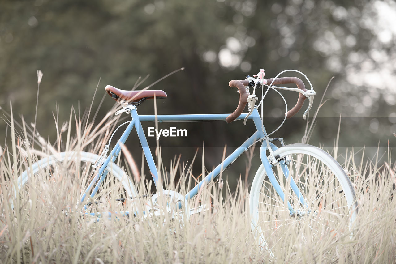 Bicycle on grassy field against sky