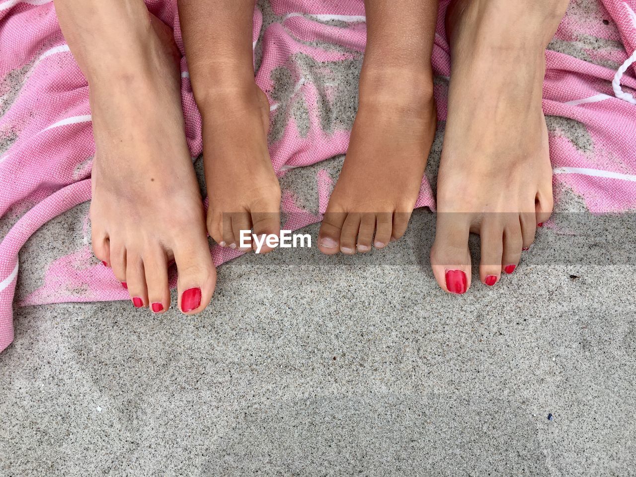 LOW SECTION OF WOMAN WITH HANDS ON PINK LEGS