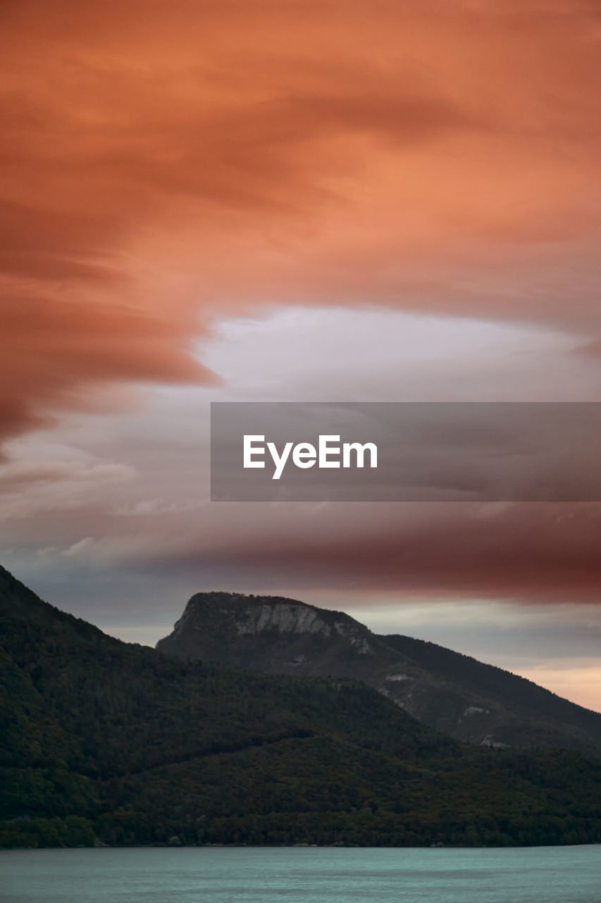 SCENIC VIEW OF MOUNTAIN AGAINST SKY AT SUNSET
