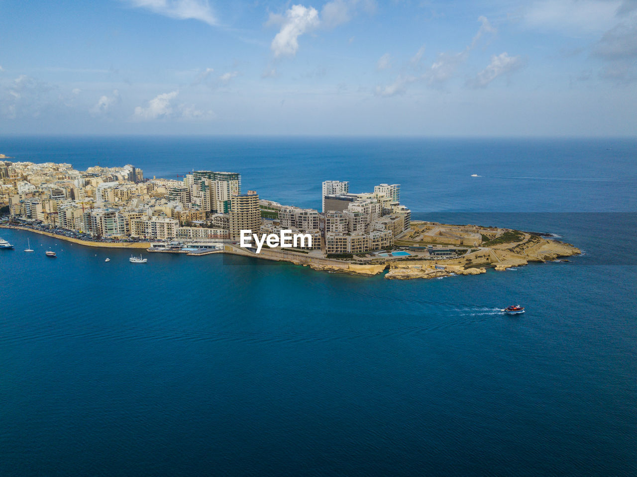 Panoramic view of sea against blue sky