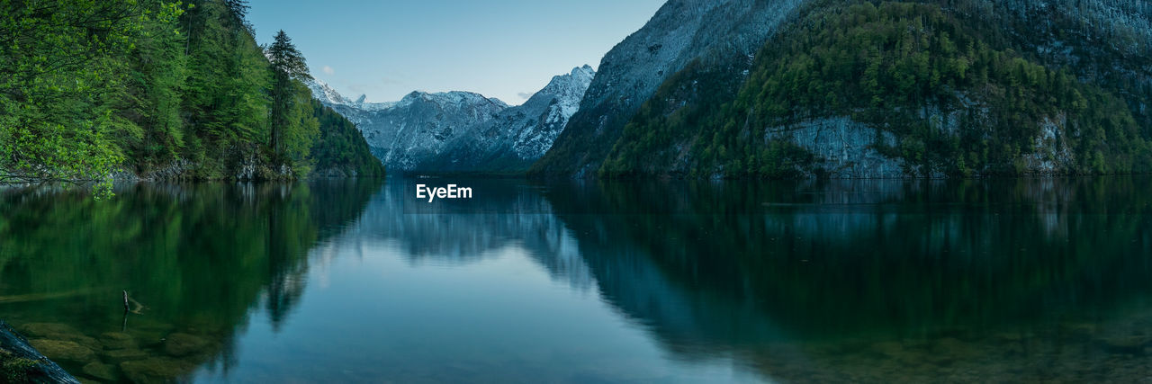 Scenic view of lake and mountains against sky