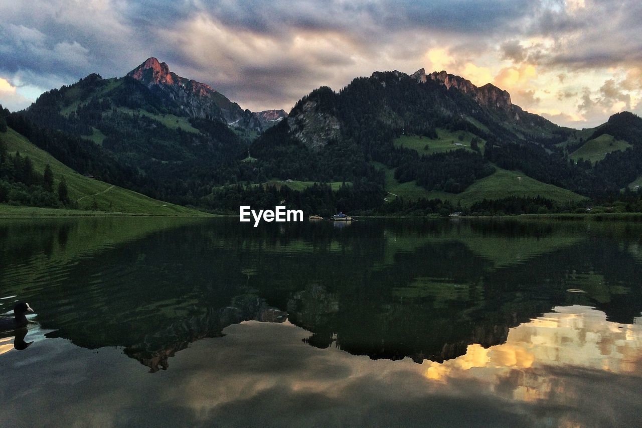 Scenic view of lake and mountains against sky