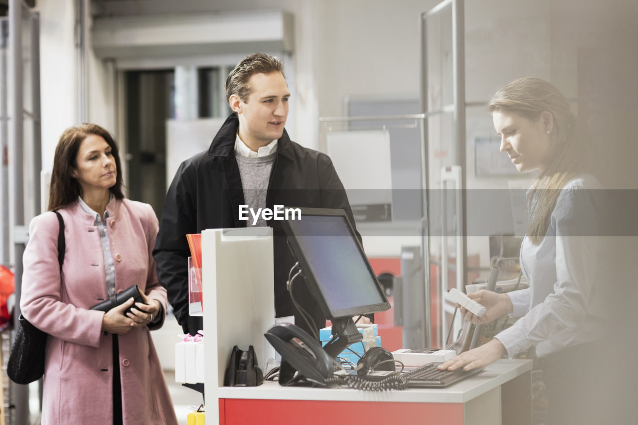 Customers standing at cash counter in showroom