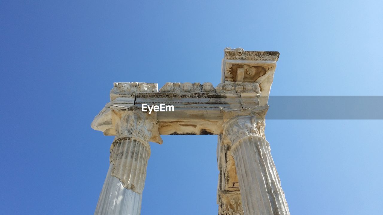 Low angle view of historical building against clear blue sky