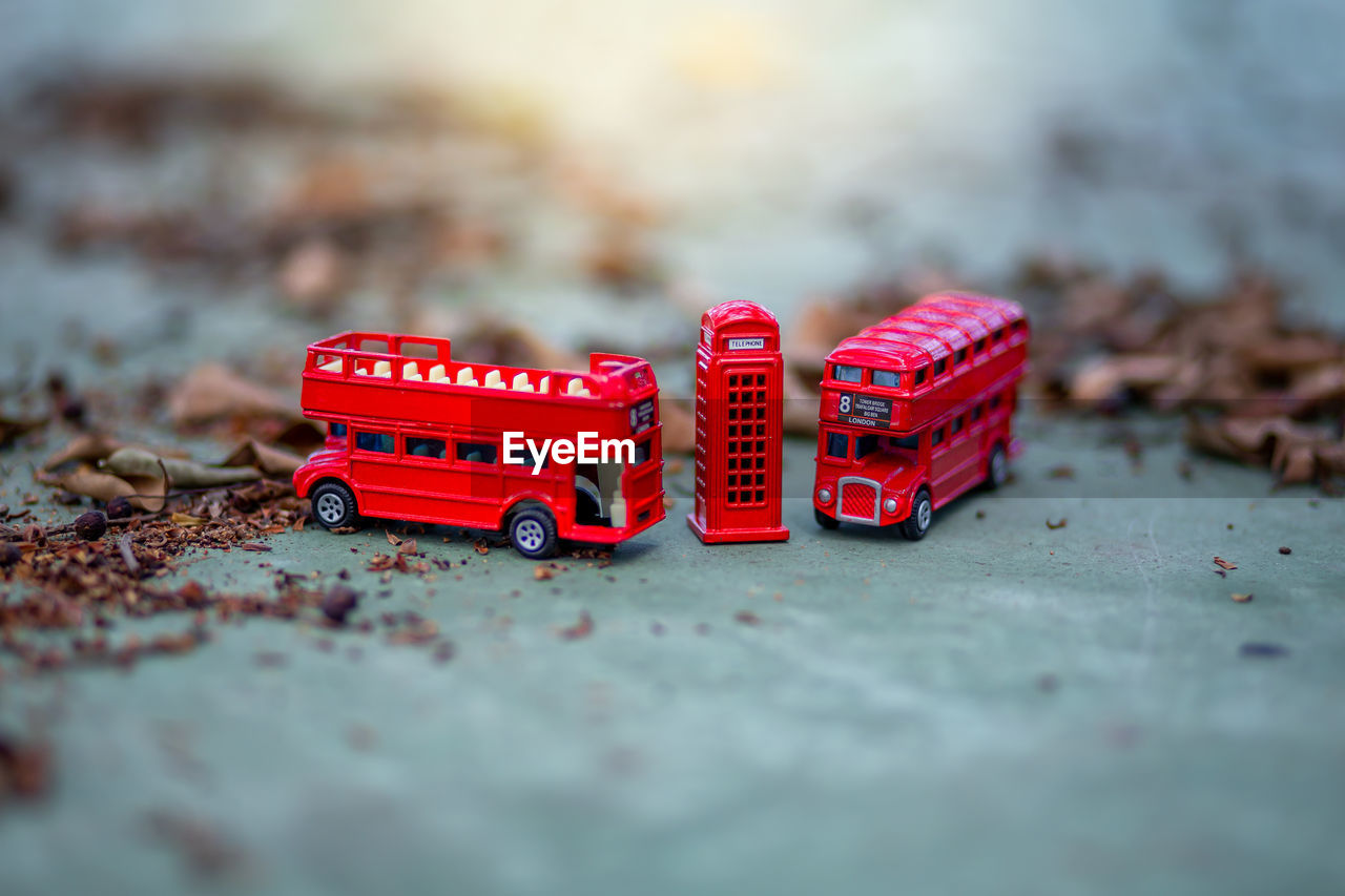 Close-up of miniature bus and telephone booth on street