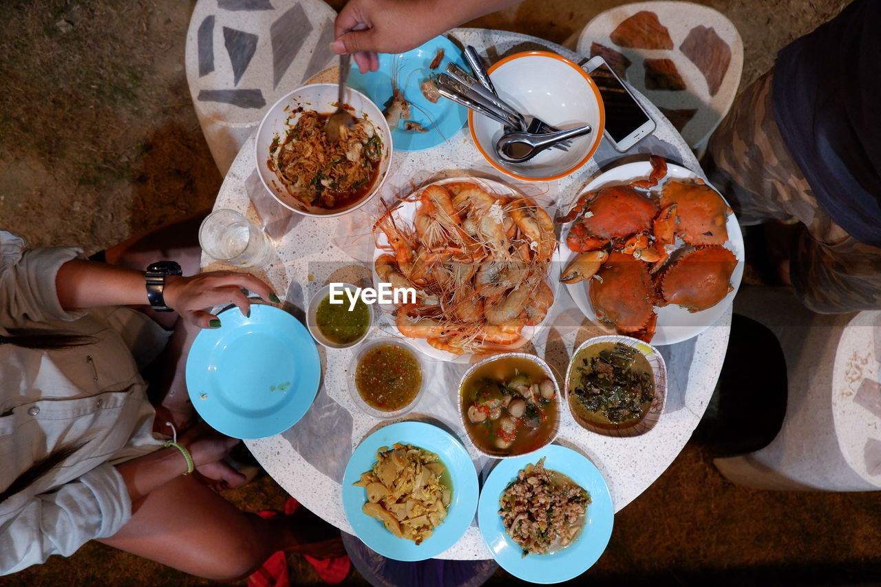 High angle view of woman having food on table