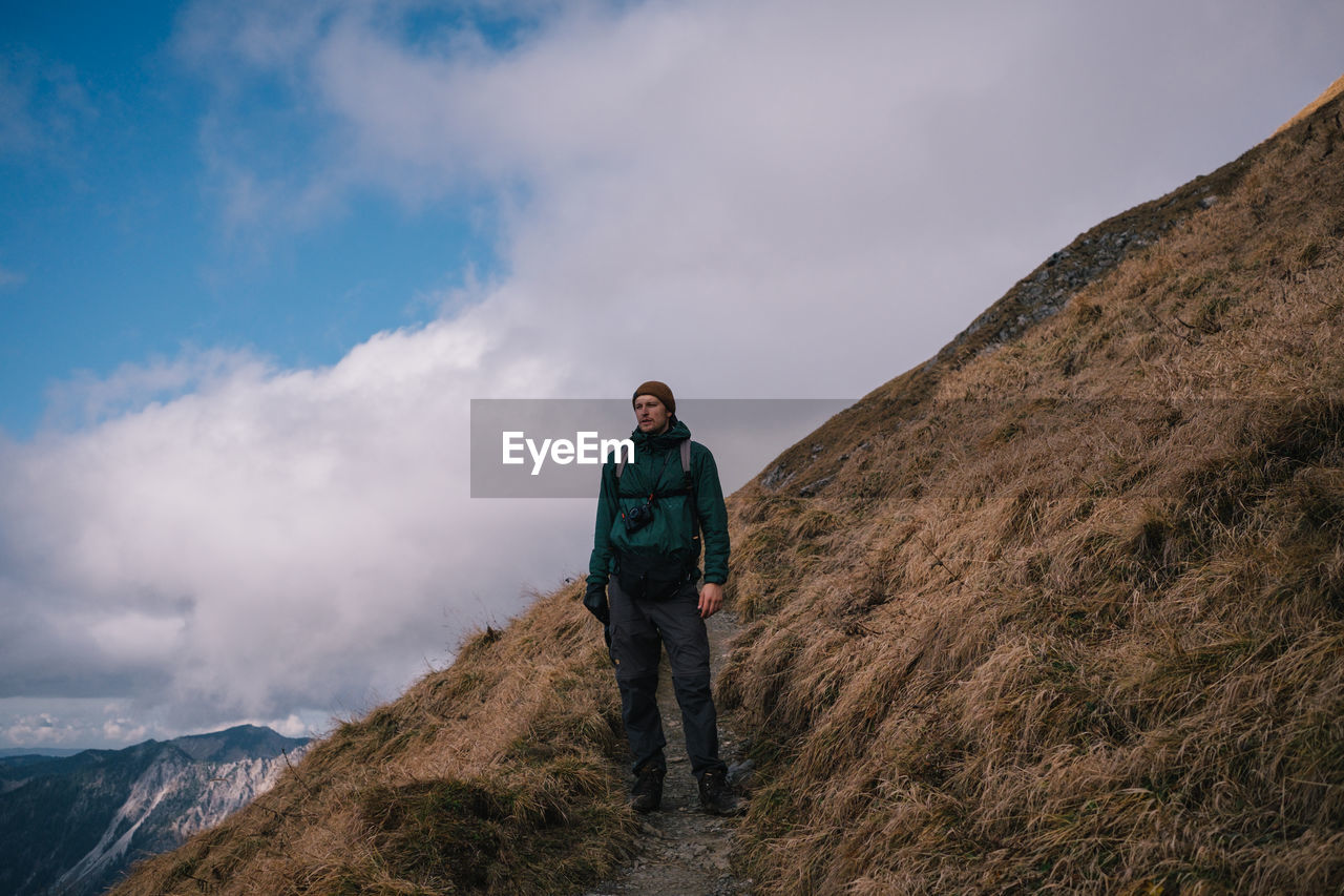 Man standing on mountain against sky