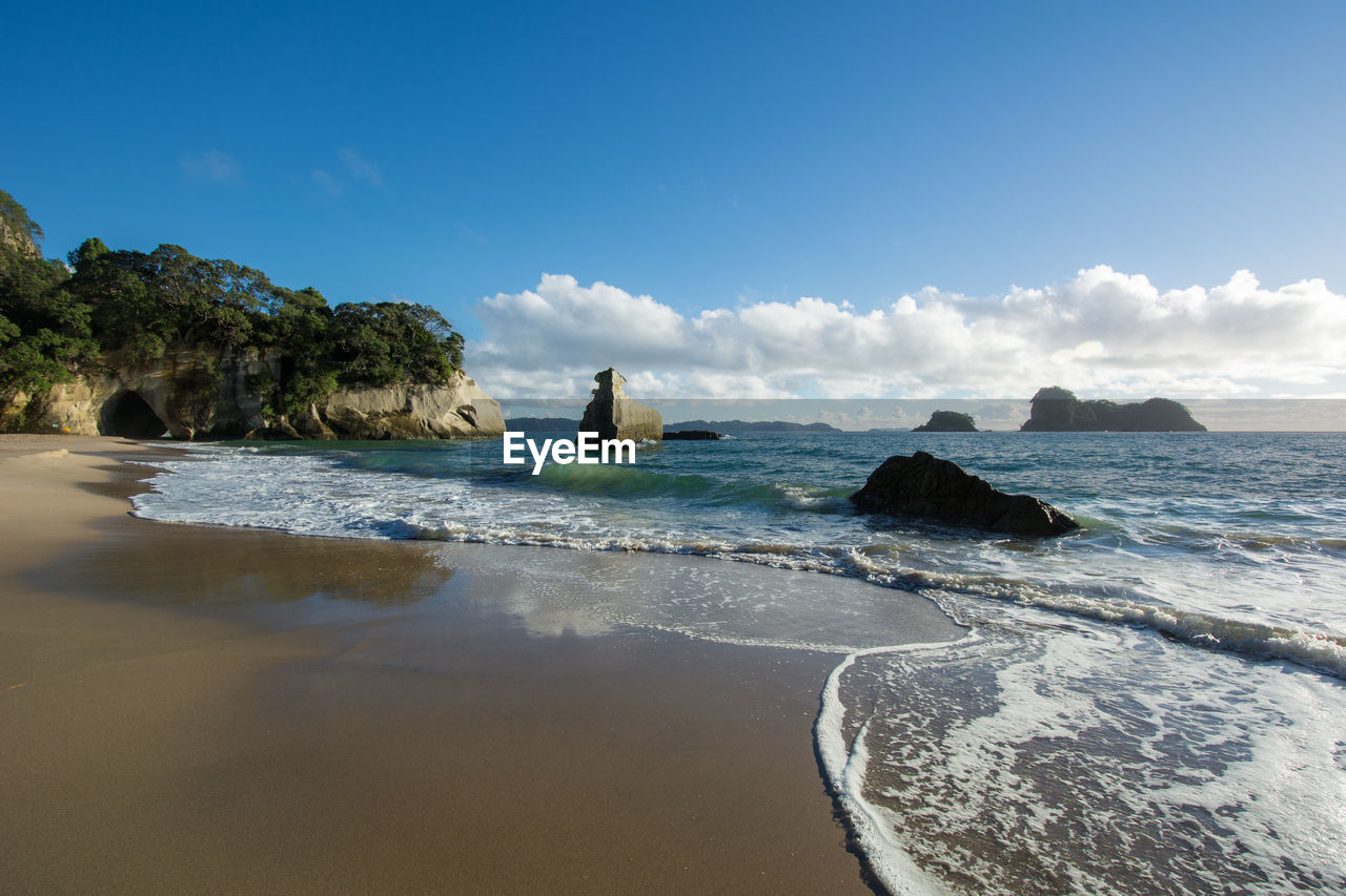 Scenic view of sea against blue sky at cathedral cove