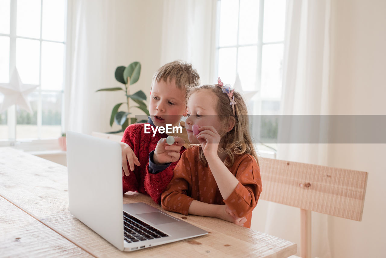 Kids showing chocolate to family on a video call during isolation