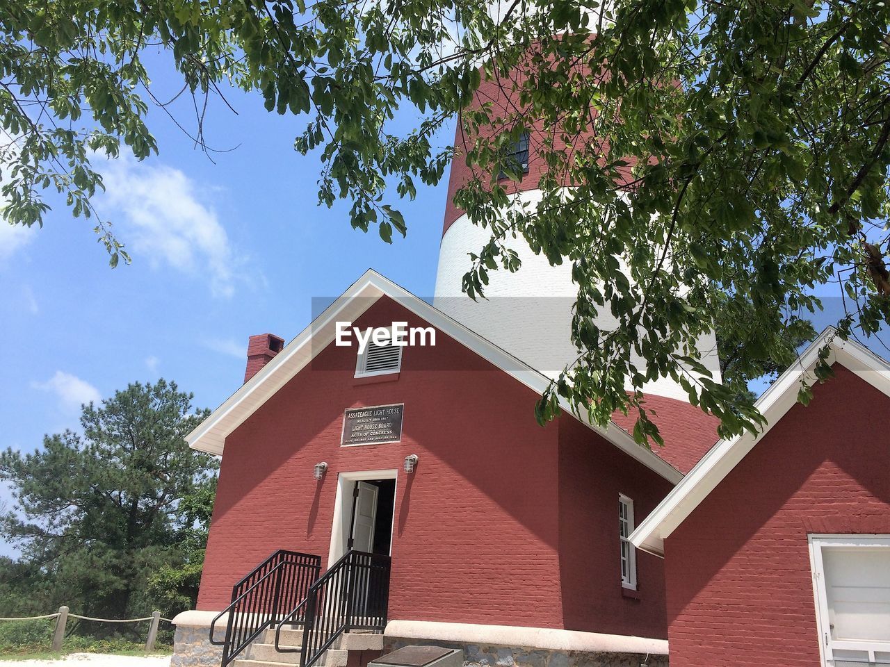 LOW ANGLE VIEW OF HOUSE AGAINST TREES