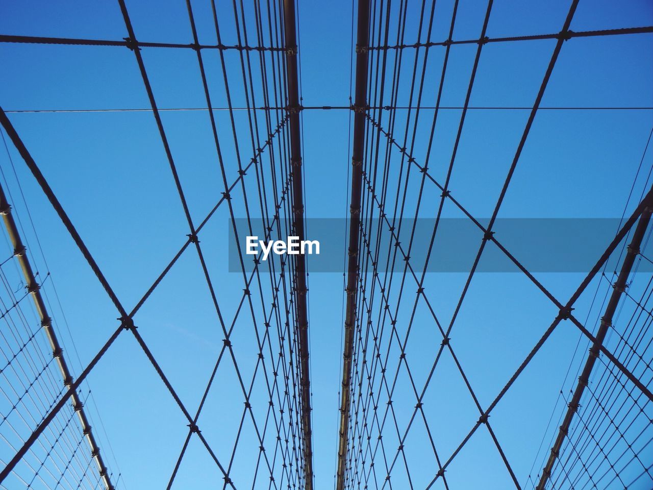 Low angle view of suspension bridge against sky