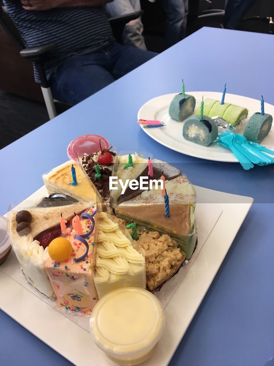 High angle view of various cake in plates on table