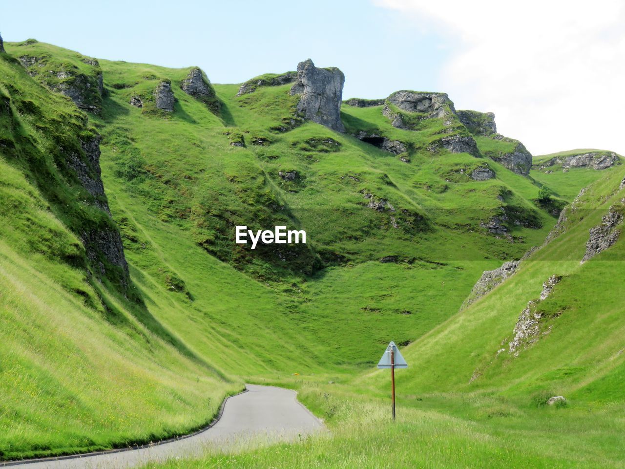 Scenic view of green landscape against sky