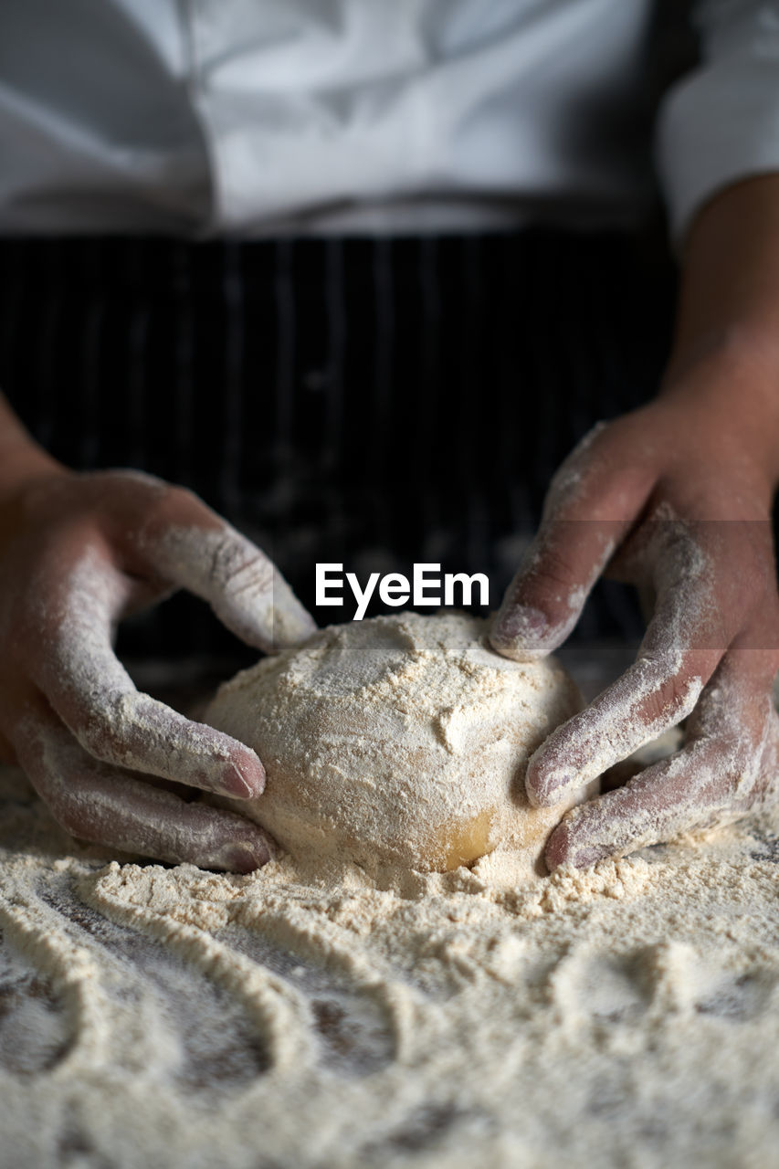 MIDSECTION OF MAN PREPARING FOOD