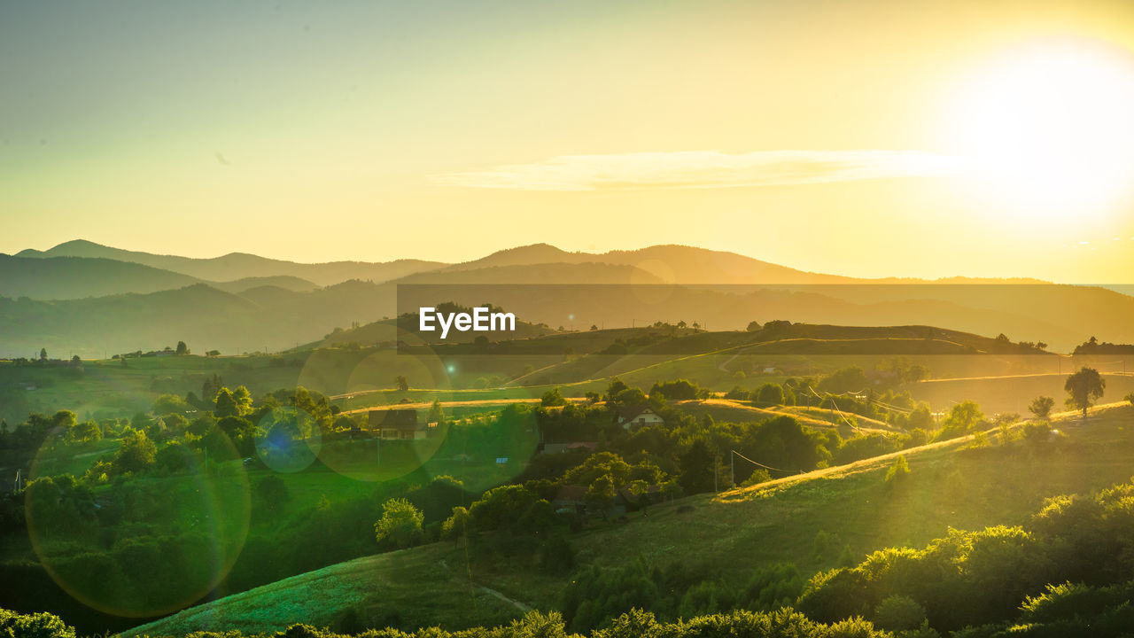 Scenic view of landscape against sky during sunset