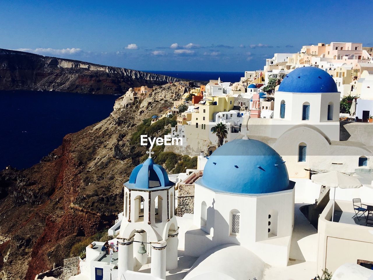 Santorini against blue sky on sunny day