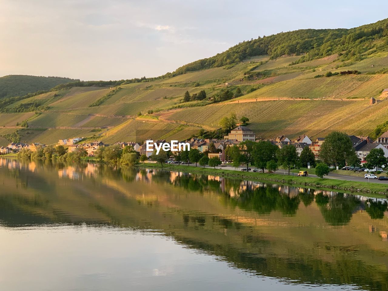 Scenic view of lake and landscape against sky