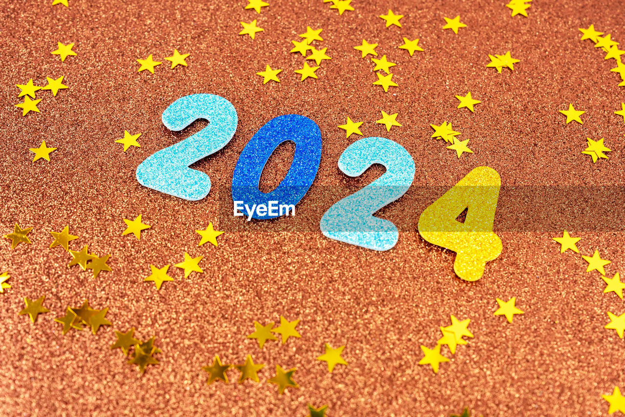 soil, yellow, font, no people, flower, communication, high angle view, multi colored, circle, text, number, leaf, day, close-up, creativity, western script