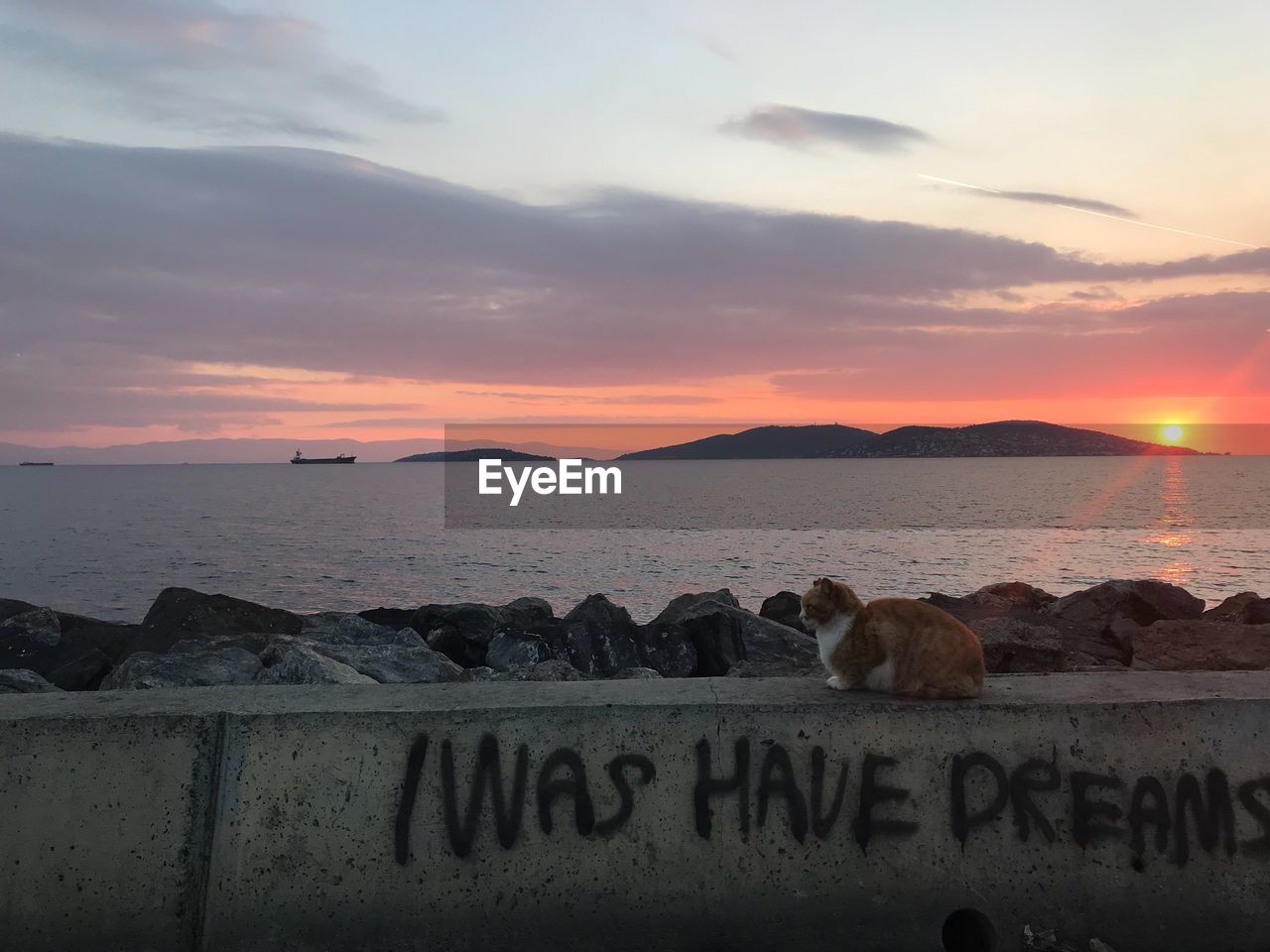 TEXT ON SHORE AGAINST SKY DURING SUNSET