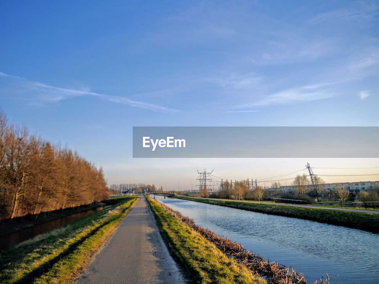 Road by river against sky