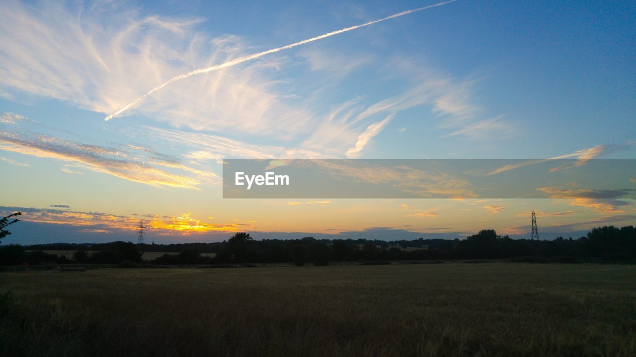 SILHOUETTE FIELD AGAINST SKY DURING SUNSET