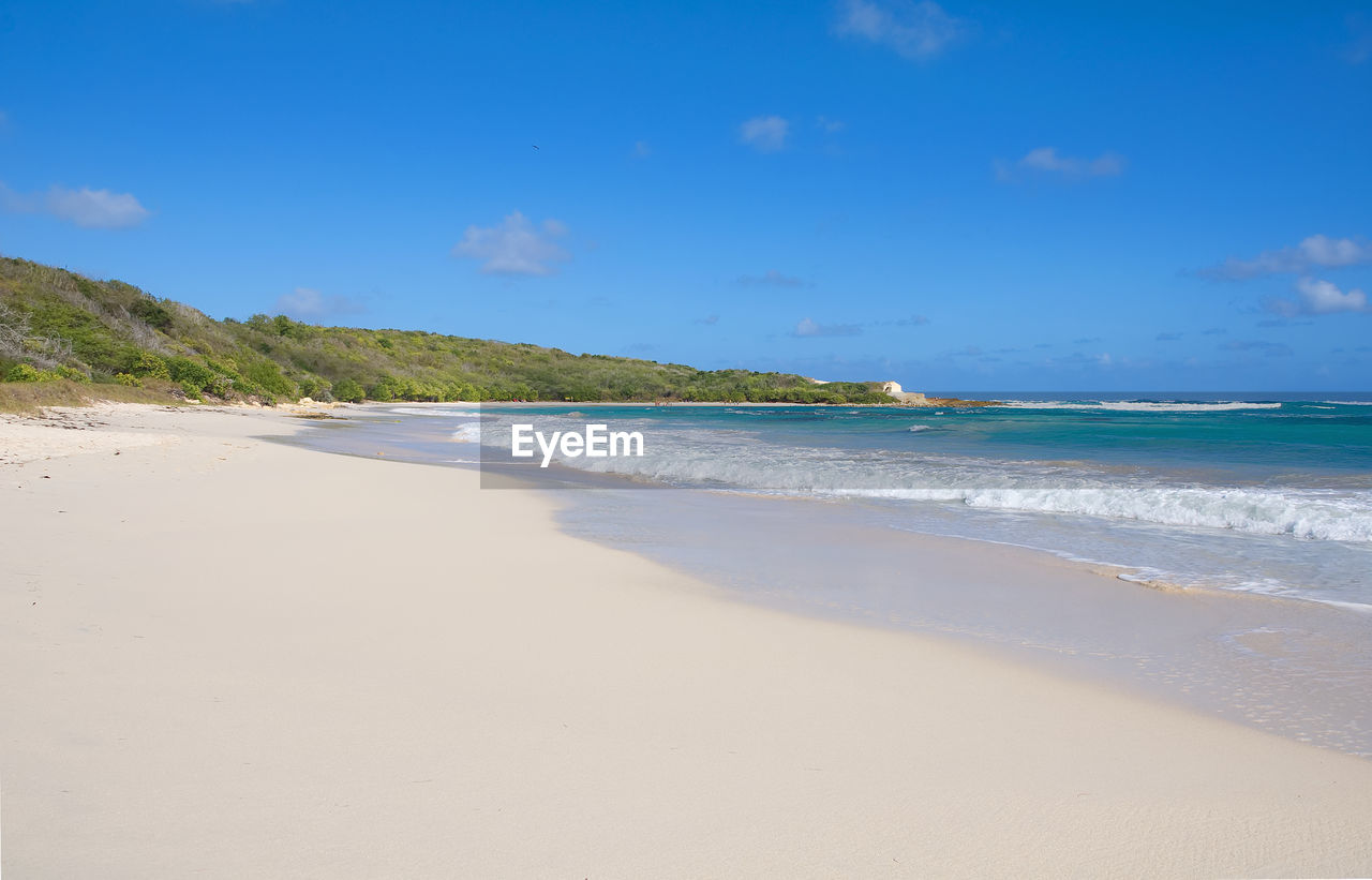 View of beach against blue sky