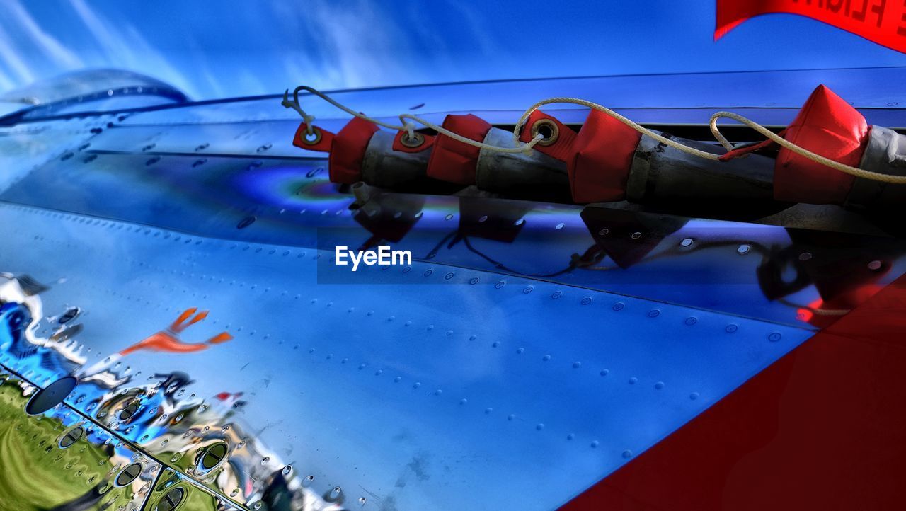CLOSE-UP OF AIRPLANE IN BLUE SKY