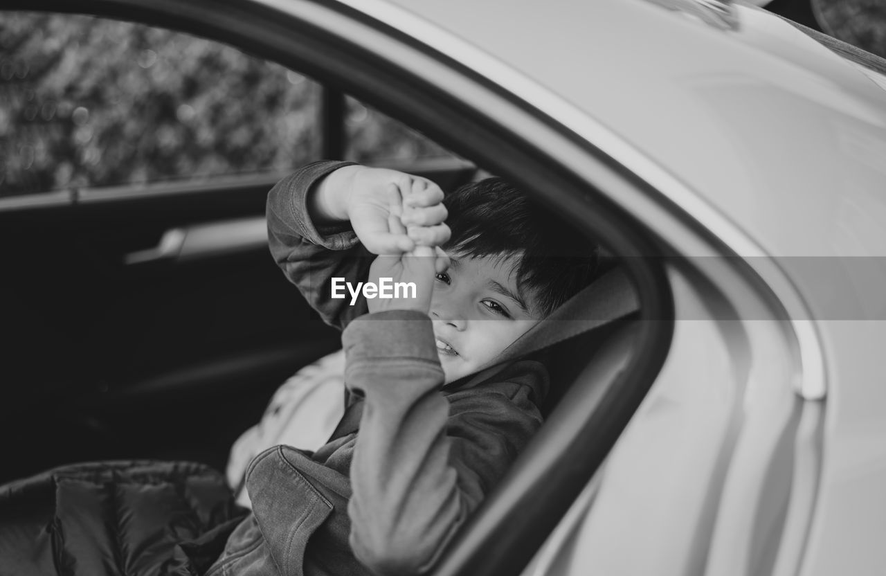 Portrait of cute boy in car