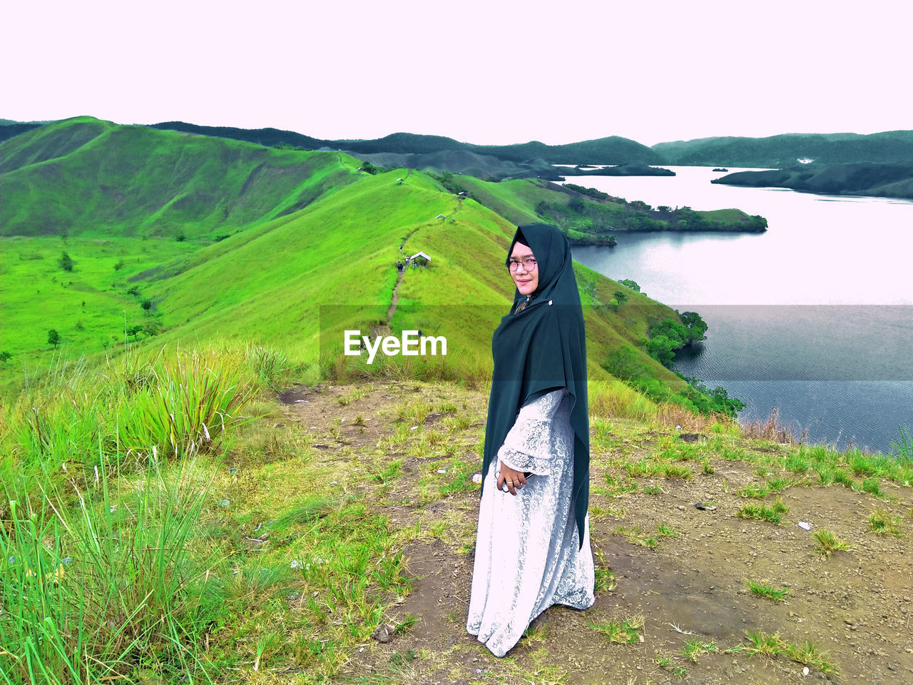 Portrait of woman in headscarf standing on mountain