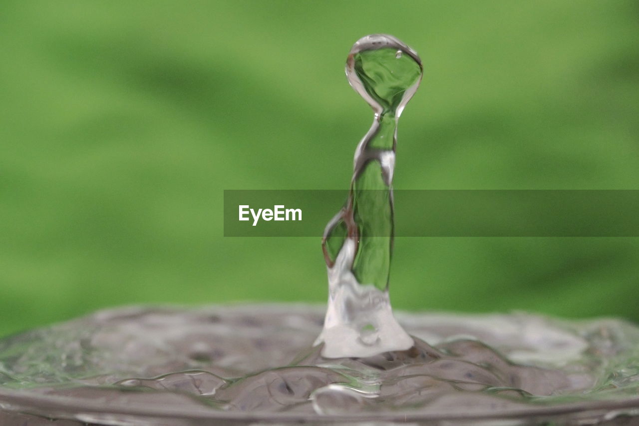 Close-up of drop falling in water