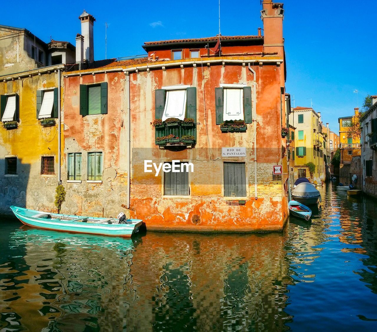 Boats in canal along buildings