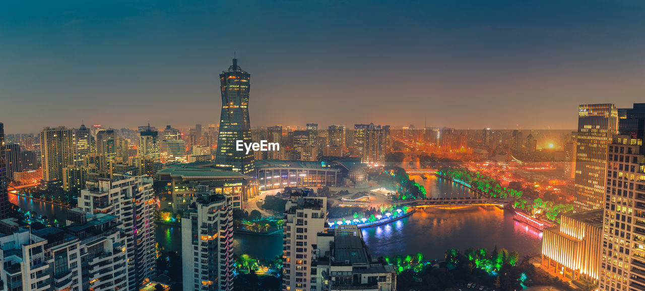 High angle view of city lit up at night