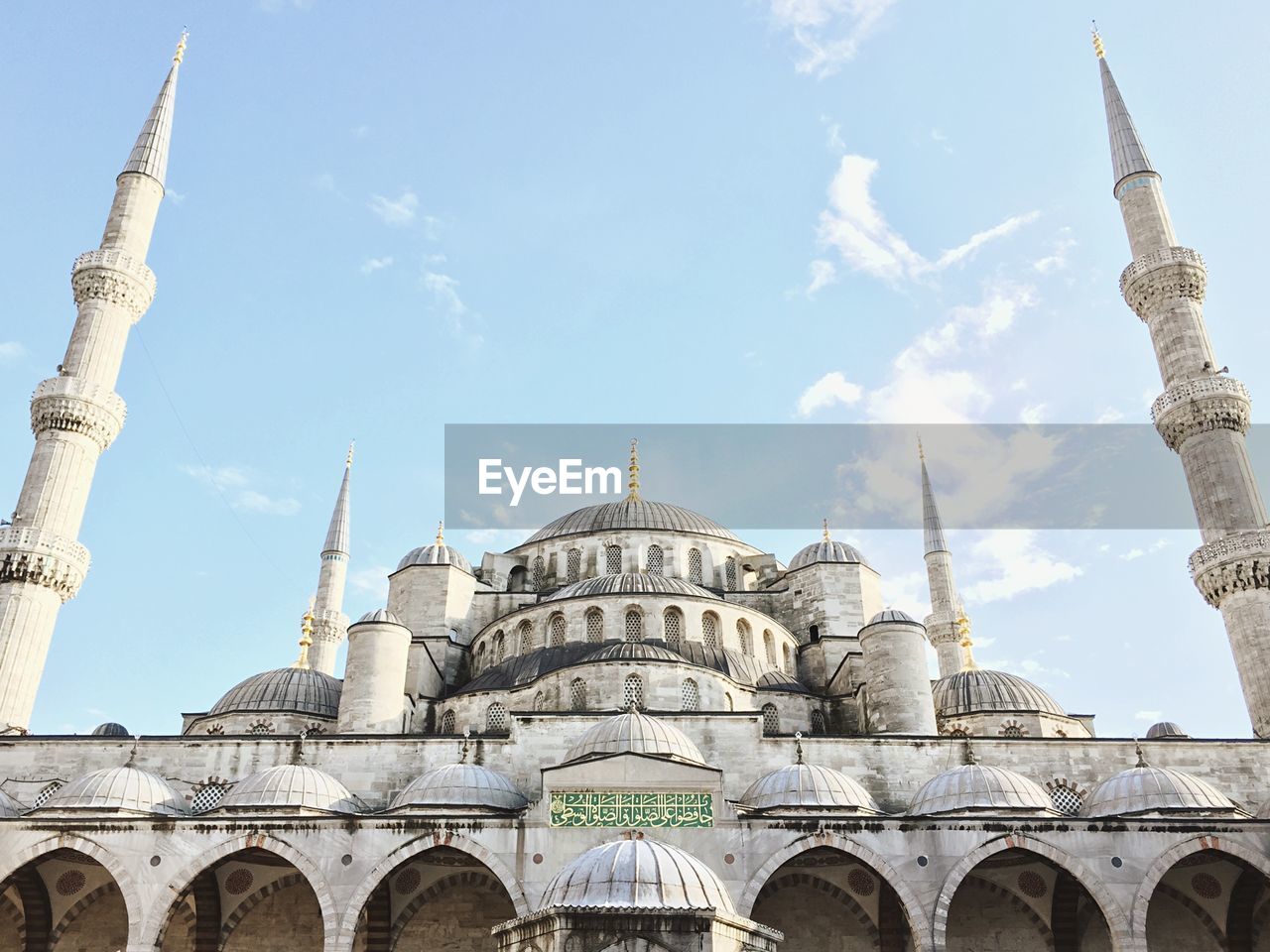 Mosque against cloudy sky