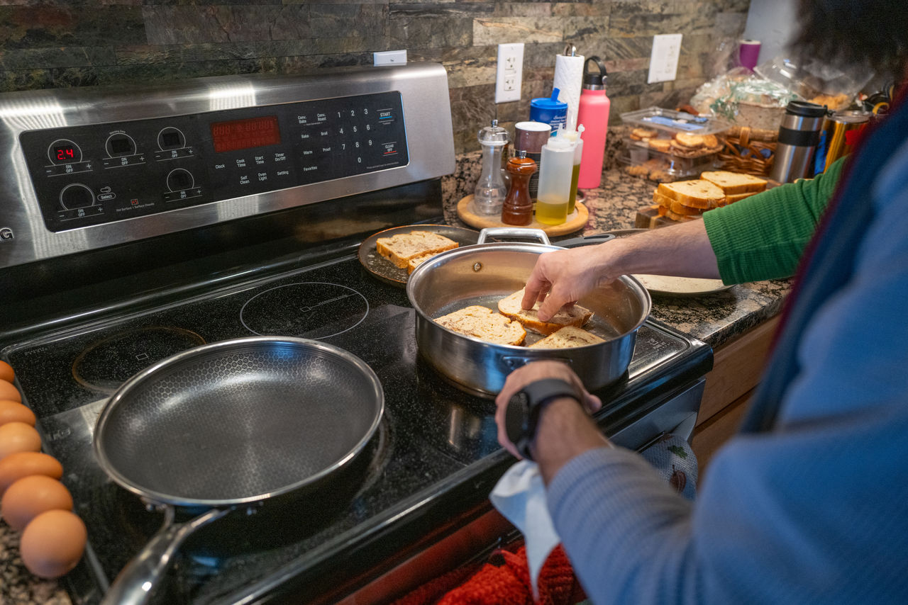 Man cooking french toast at home in his kitchen
